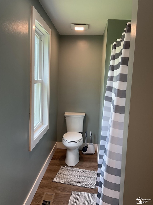 18200 Sherman, Milan, MI 48160 - full bathroom featuring toilet, wood finished floors, baseboards, and a shower with shower curtain