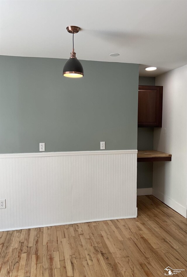 18200 Sherman, Milan, MI 48160 - empty room with wood finished floors, baseboards, and wainscoting