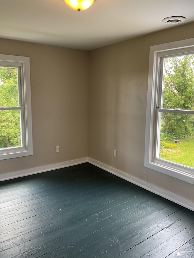 18200 Sherman, Milan, MI 48160 - unfurnished room with dark wood-type flooring, healthy amount of natural light, and baseboards