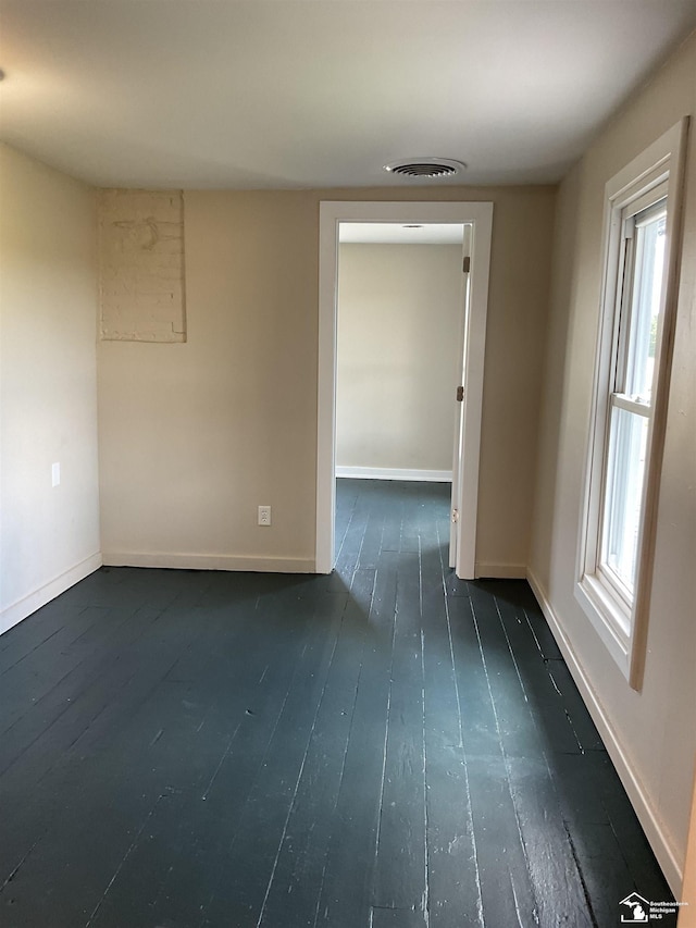 18200 Sherman, Milan, MI 48160 - spare room featuring dark wood finished floors and baseboards