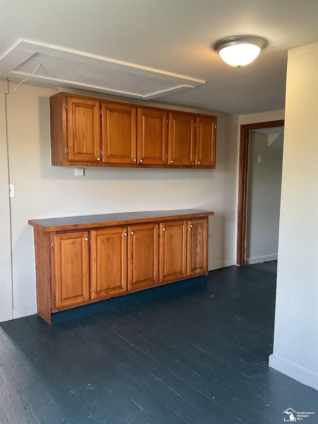 18200 Sherman, Milan, MI 48160 - kitchen featuring brown cabinetry, dark wood-type flooring, and baseboards