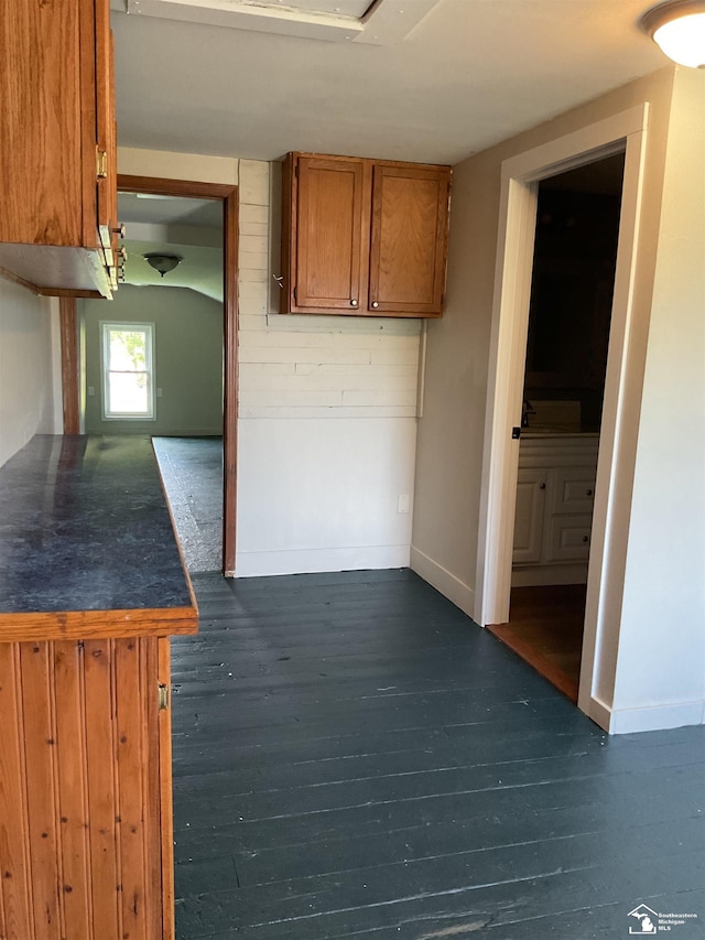 18200 Sherman, Milan, MI 48160 - kitchen with brown cabinets, baseboards, dark countertops, and dark wood-type flooring
