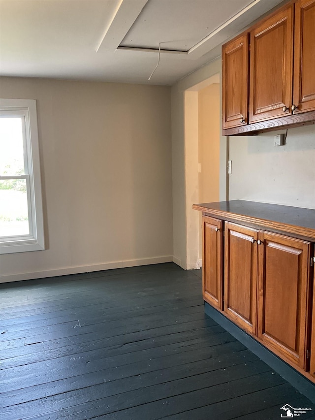 18200 Sherman, Milan, MI 48160 - kitchen with brown cabinetry, dark wood finished floors, dark countertops, and baseboards