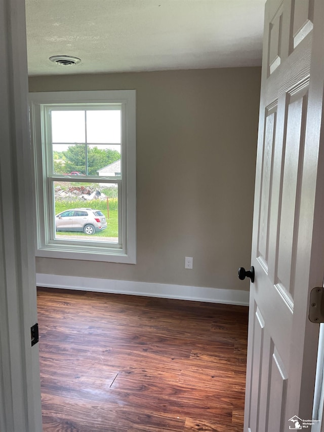 18200 Sherman, Milan, MI 48160 - empty room with dark wood-type flooring and baseboards