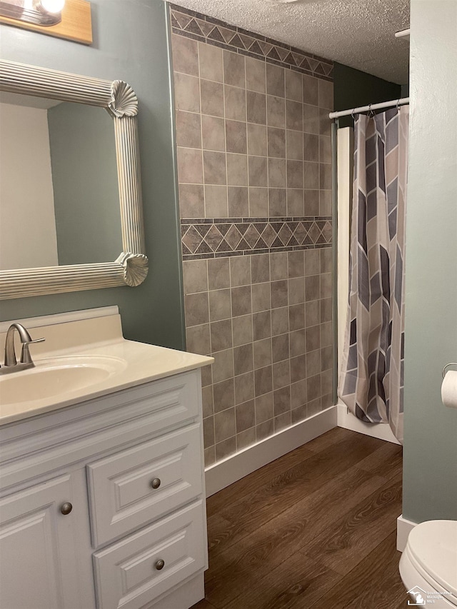 18200 Sherman, Milan, MI 48160 - bathroom with vanity, wood finished floors, a textured ceiling, toilet, and a shower with curtain