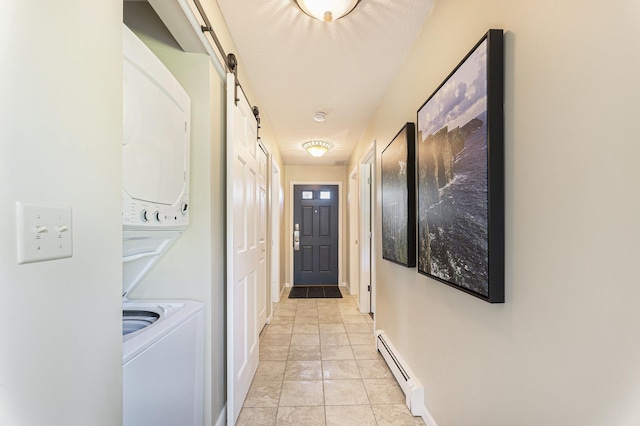 5737 Hilltop Way, Williamsburg, MI 49690 - hall with baseboard heating, stacked washing machine and dryer, a barn door, baseboards, and light tile patterned floors