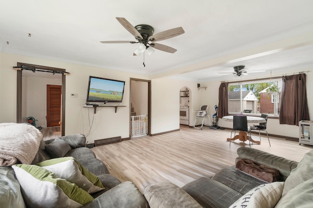 111 Greenleaf St, Onsted, MI 49265 - living area featuring ceiling fan, baseboards, light wood-style flooring, and arched walkways