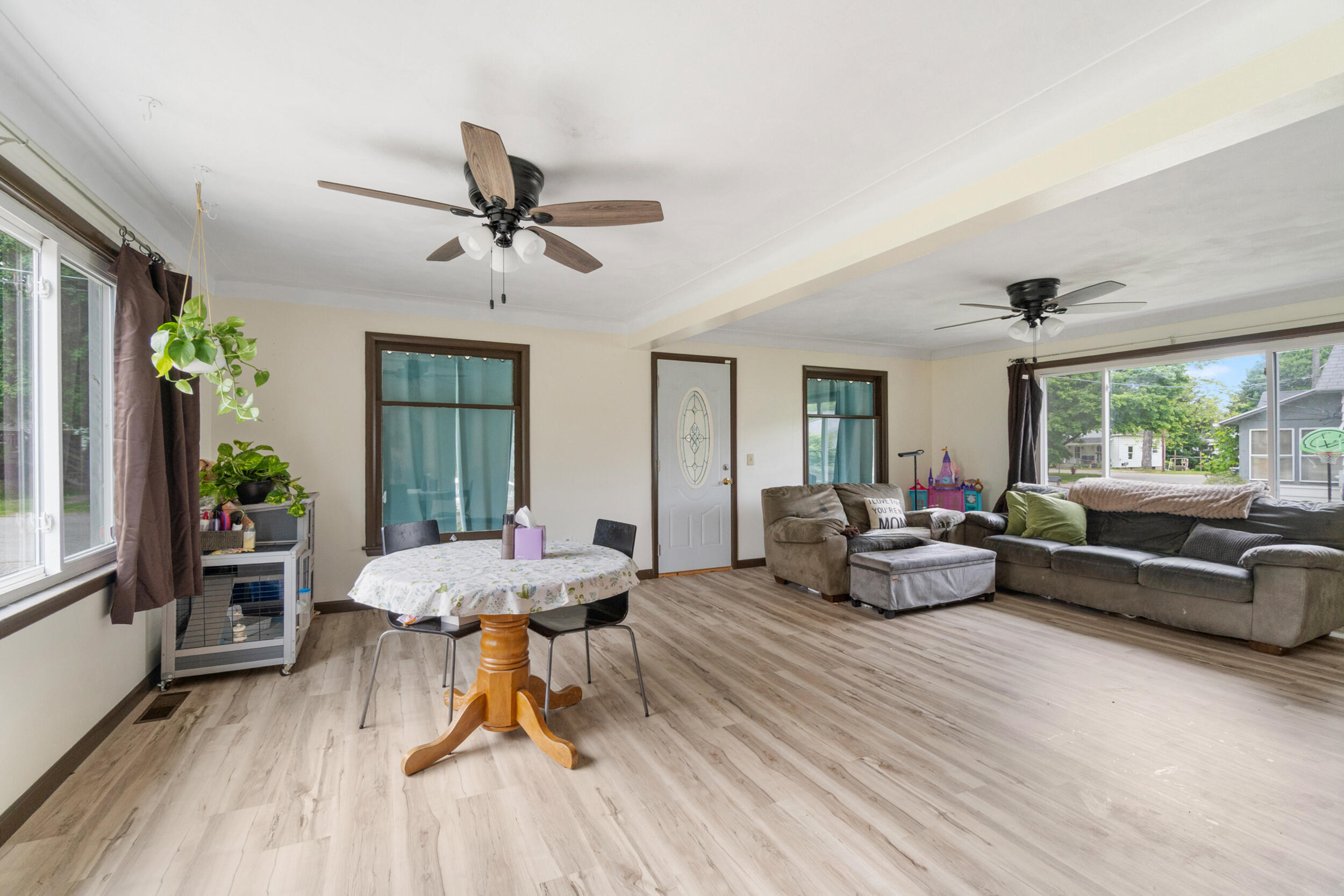 111 Greenleaf St, Onsted, MI 49265 - living room with light wood finished floors, a ceiling fan, baseboards, and crown molding