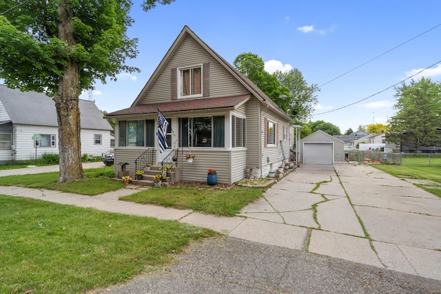 111 Greenleaf St, Onsted, MI 49265 - bungalow with a front lawn, driveway, a detached garage, and an outbuilding
