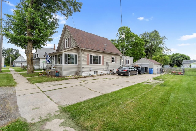 111 Greenleaf St, Onsted, MI 49265 - view of front of home with a detached garage, roof with shingles, and an outdoor structure
