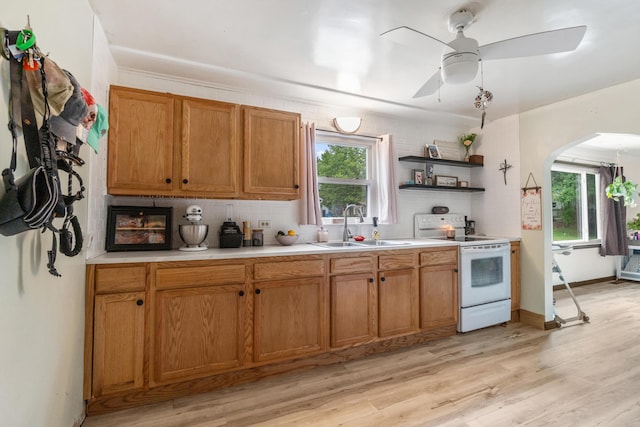 111 Greenleaf St, Onsted, MI 49265 - kitchen featuring white range with electric stovetop, a sink, light countertops, a ceiling fan, and arched walkways