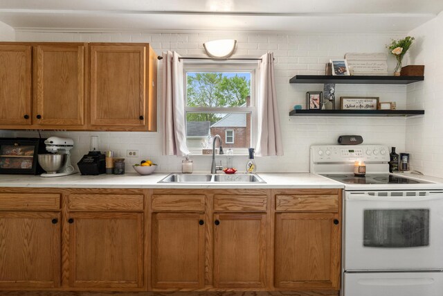 111 Greenleaf St, Onsted, MI 49265 - kitchen featuring electric range, a sink, light countertops, and backsplash