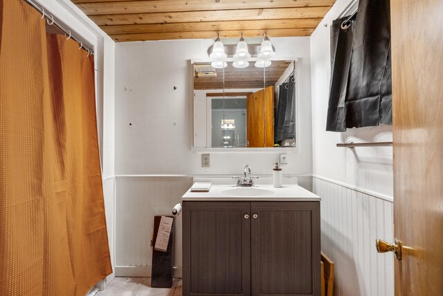 111 Greenleaf St, Onsted, MI 49265 - bathroom featuring a wainscoted wall, vanity, wooden ceiling, and curtained shower