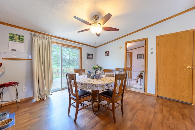 8279 Luce St, Alanson, MI 49706 - dining area with light wood-style flooring, a ceiling fan, ornamental molding, baseboards, and vaulted ceiling