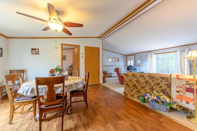 8279 Luce St, Alanson, MI 49706 - dining area with wood finished floors, crown molding, lofted ceiling, and ceiling fan