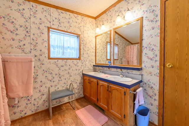 8279 Luce St, Alanson, MI 49706 - full bath featuring wood finished floors, ornamental molding, double vanity, and wallpapered walls