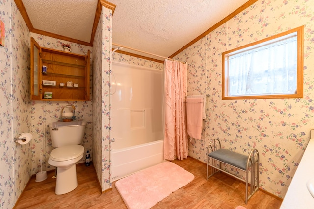 8279 Luce St, Alanson, MI 49706 - full bath with ornamental molding, wood finished floors, toilet, a textured ceiling, and shower / tub combo