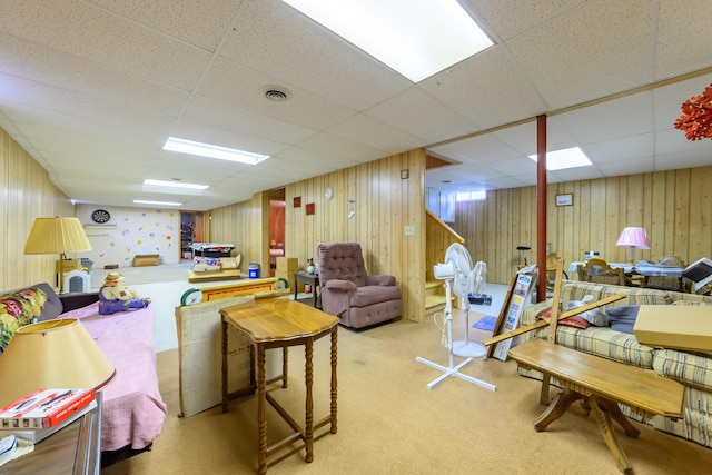 8279 Luce St, Alanson, MI 49706 - living area with a paneled ceiling, carpet floors, and wood walls