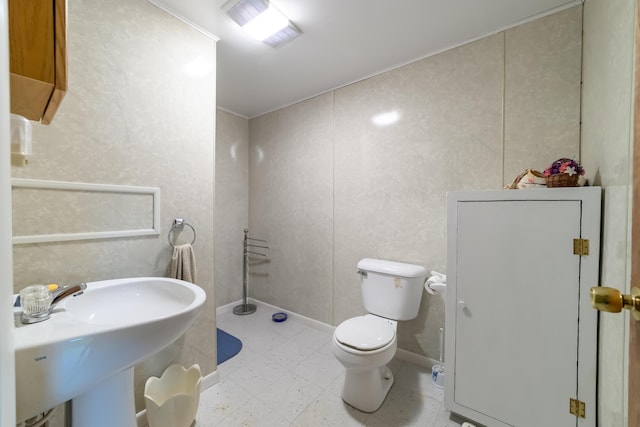8279 Luce St, Alanson, MI 49706 - bathroom featuring toilet, a sink, tile patterned floors, and baseboards