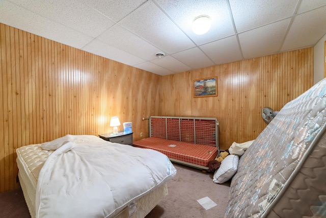 8279 Luce St, Alanson, MI 49706 - carpeted bedroom with wooden walls and a paneled ceiling