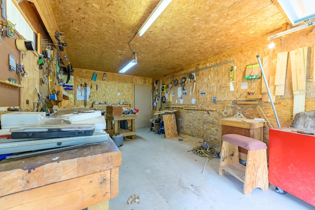 8279 Luce St, Alanson, MI 49706 - miscellaneous room featuring a workshop area and unfinished concrete flooring