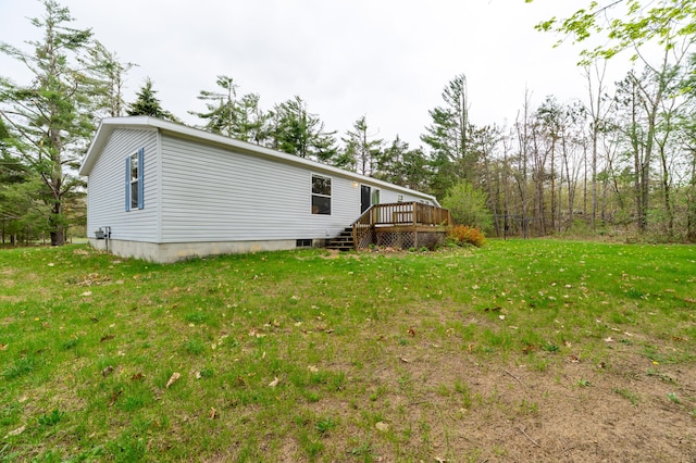 8279 Luce St, Alanson, MI 49706 - back of property featuring a wooden deck and a yard
