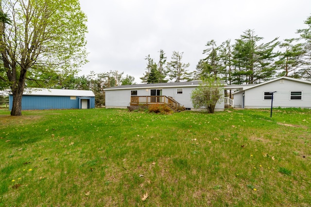 8279 Luce St, Alanson, MI 49706 - back of house with a deck, a yard, and an outdoor structure