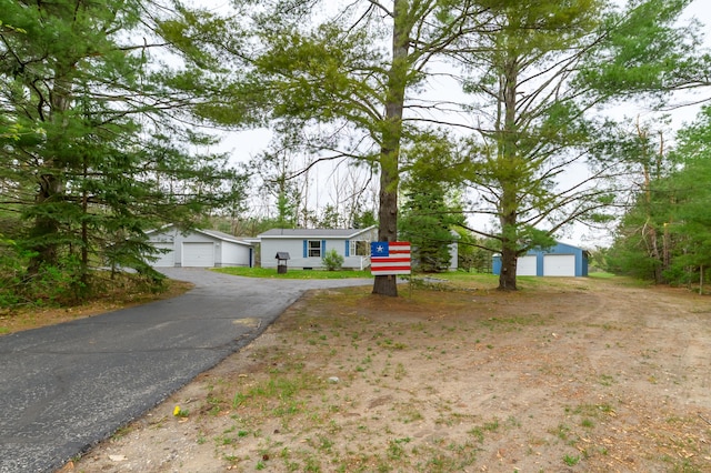 8279 Luce St, Alanson, MI 49706 - view of front of house with a detached garage and an outdoor structure