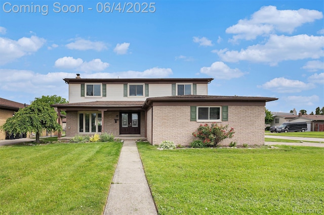 4325 Fox Hill Dr, Sterling Heights, MI 48310 - traditional home with a front yard, brick siding, and a chimney