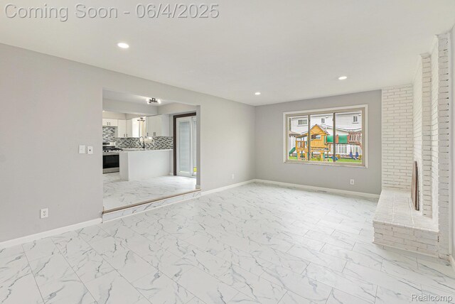 4325 Fox Hill Dr, Sterling Heights, MI 48310 - unfurnished living room with light marble finish flooring, baseboards, and recessed lighting