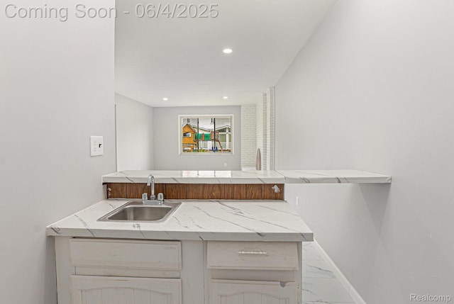 4325 Fox Hill Dr, Sterling Heights, MI 48310 - kitchen with a sink, marble finish floors, light stone counters, a peninsula, and recessed lighting