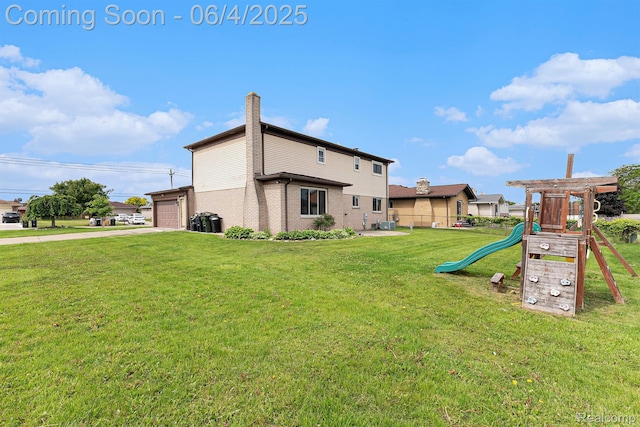 4325 Fox Hill Dr, Sterling Heights, MI 48310 - rear view of house with a yard, a playground, brick siding, driveway, and an attached garage