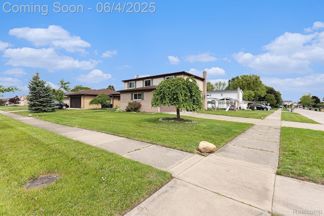 4325 Fox Hill Dr, Sterling Heights, MI 48310 - view of front of house with a front lawn and brick siding