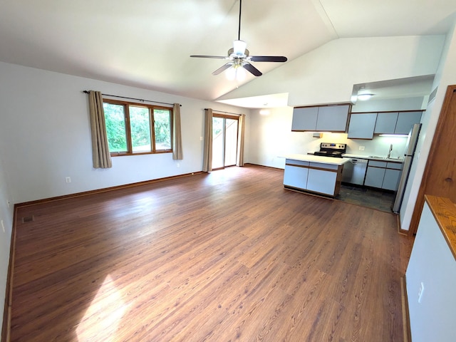 599 Echo Ct, Saline, MI 48176 - kitchen with vaulted ceiling, a ceiling fan, electric range, open floor plan, and dark wood-style floors