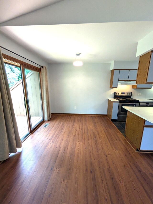 599 Echo Ct, Saline, MI 48176 - kitchen with stainless steel electric range, under cabinet range hood, baseboards, light countertops, and dark wood-type flooring