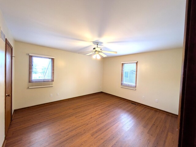 599 Echo Ct, Saline, MI 48176 - unfurnished room featuring plenty of natural light, ceiling fan, wood finished floors, and baseboards