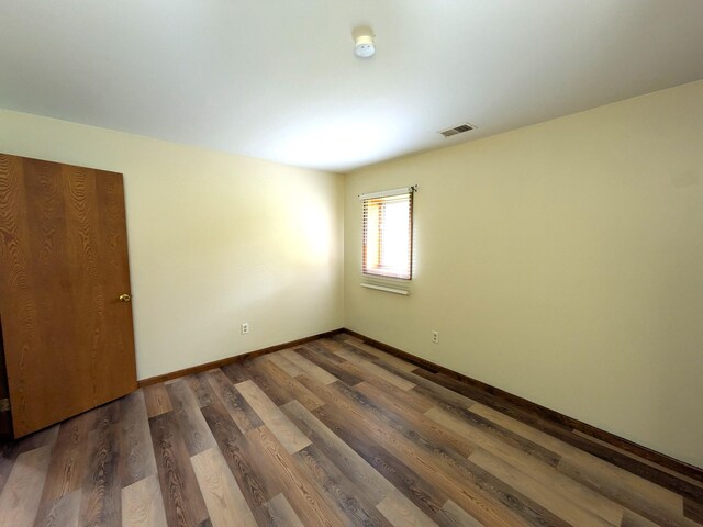 599 Echo Ct, Saline, MI 48176 - unfurnished room featuring baseboards, wood finished floors, and a smoke detector