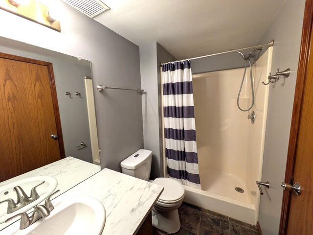 599 Echo Ct, Saline, MI 48176 - bathroom with toilet, vanity, a shower with curtain, and stone finish flooring