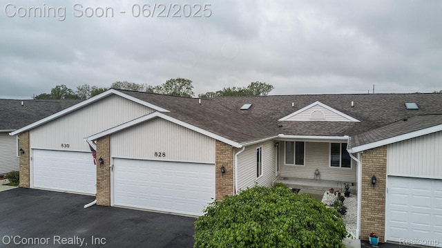 828 Crystal Ln, Marysville, MI 48040 - view of front facade with brick siding, a shingled roof, asphalt driveway, and a garage