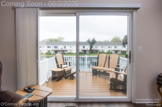 828 Crystal Ln, Marysville, MI 48040 - doorway to outside featuring a residential view, wood finished floors, and a water view