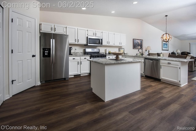 828 Crystal Ln, Marysville, MI 48040 - kitchen featuring stainless steel appliances, a peninsula, vaulted ceiling, white cabinetry, and pendant lighting
