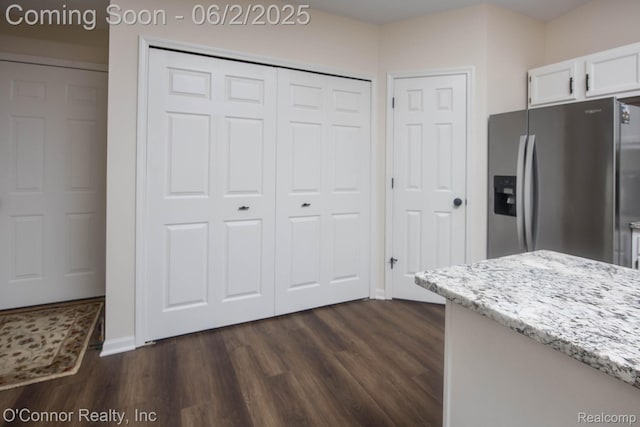 828 Crystal Ln, Marysville, MI 48040 - kitchen featuring stainless steel fridge with ice dispenser, light stone counters, white cabinets, dark wood finished floors, and baseboards