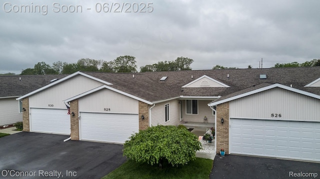 828 Crystal Ln, Marysville, MI 48040 - view of front facade featuring brick siding, a shingled roof, a garage, and driveway