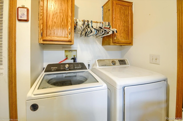 355 Carpenter Rd, Fostoria, MI 48435 - laundry area featuring cabinet space and separate washer and dryer