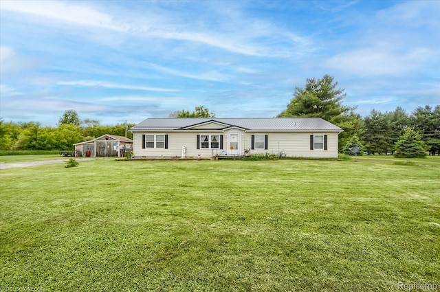 355 Carpenter Rd, Fostoria, MI 48435 - view of front of house featuring a front yard and metal roof