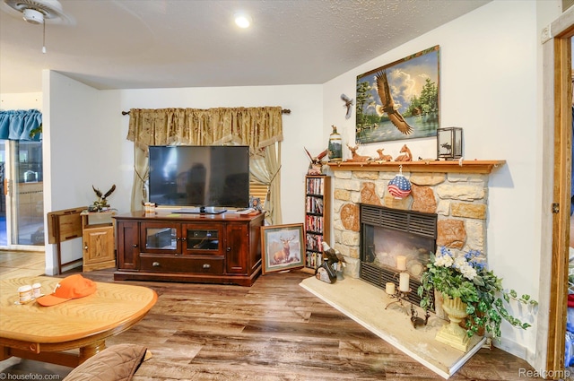 355 Carpenter Rd, Fostoria, MI 48435 - living room with wood finished floors, a stone fireplace, and ceiling fan