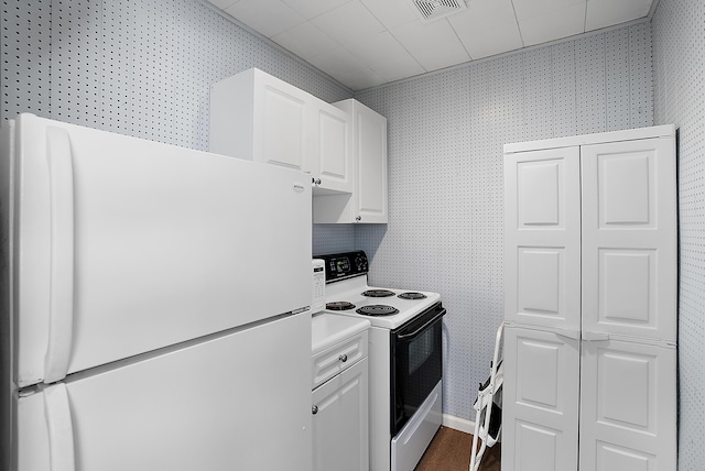 6130 Eidson Rd, Saint Joseph, MI 49085 - kitchen featuring white appliances, wallpapered walls, white cabinetry, and light countertops