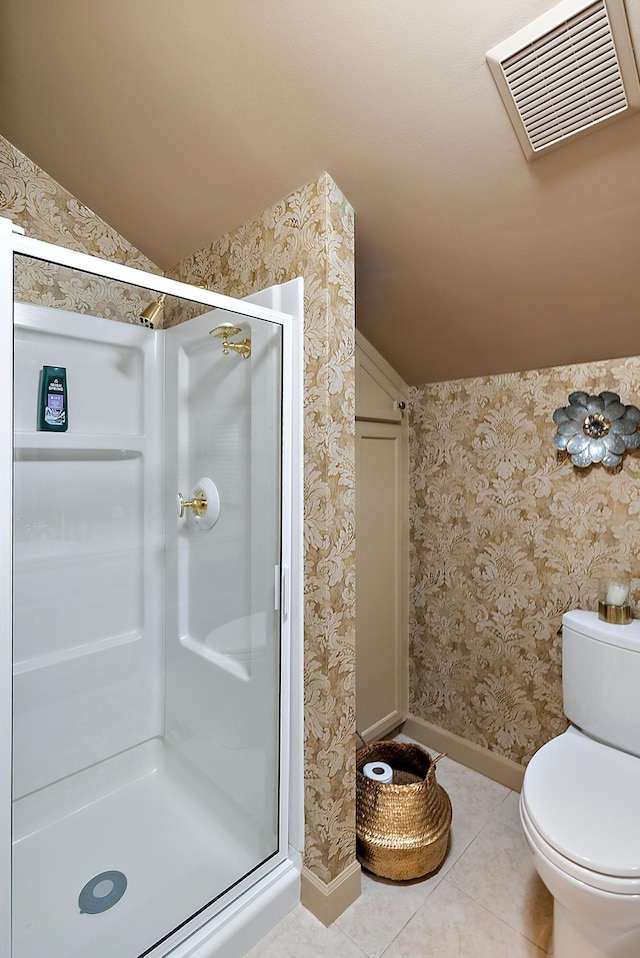 6130 Eidson Rd, Saint Joseph, MI 49085 - full bath featuring vaulted ceiling, a shower stall, baseboards, toilet, and tile patterned flooring