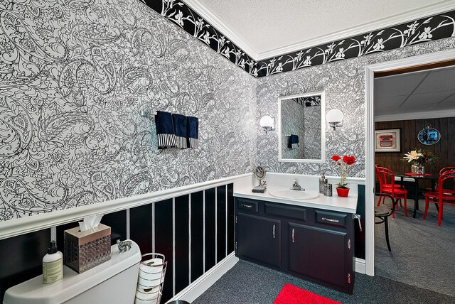6130 Eidson Rd, Saint Joseph, MI 49085 - bathroom featuring crown molding, wallpapered walls, vanity, toilet, and a textured ceiling