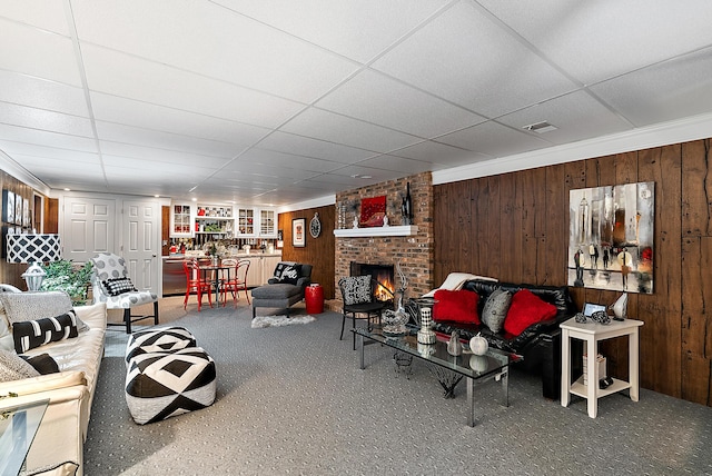 6130 Eidson Rd, Saint Joseph, MI 49085 - living area with carpet, a drop ceiling, wooden walls, and a fireplace